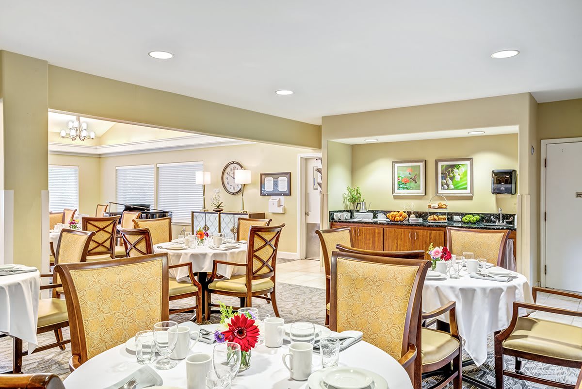 An elegant dining room with set tables and stylish decor.