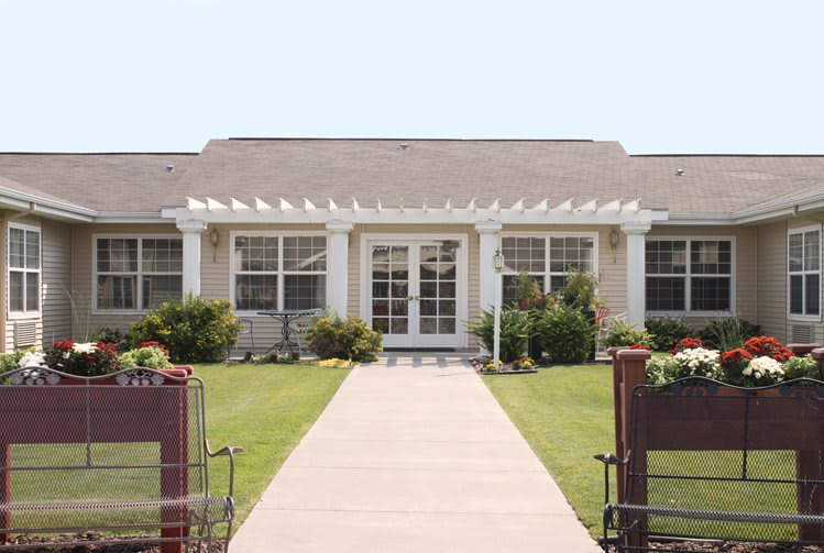 A single-story house with a well-maintained front yard and pathway leading to the entrance.