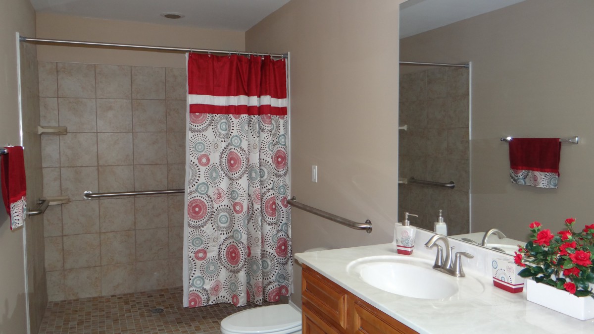 A bathroom with a colorful shower curtain and a clean countertop.