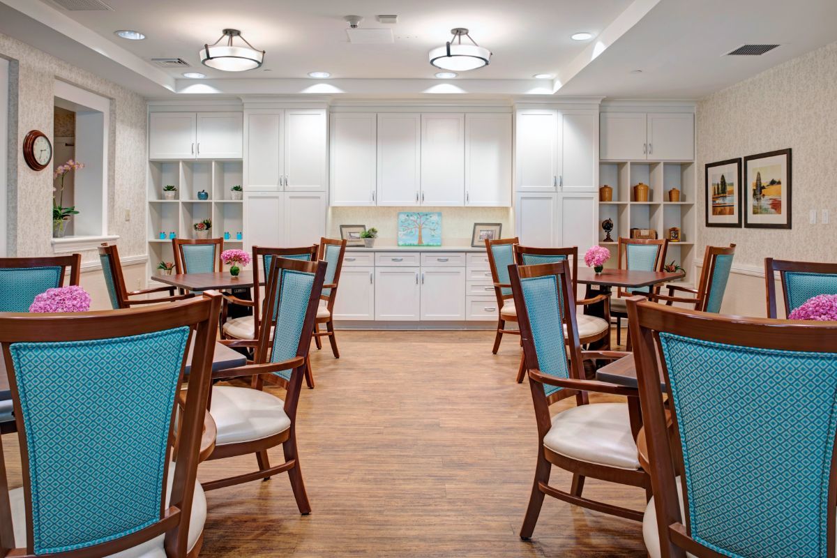 A modern dining room with elegant chairs and tables arranged neatly.