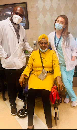 A cheerful moment captured with a patient and her healthcare team.