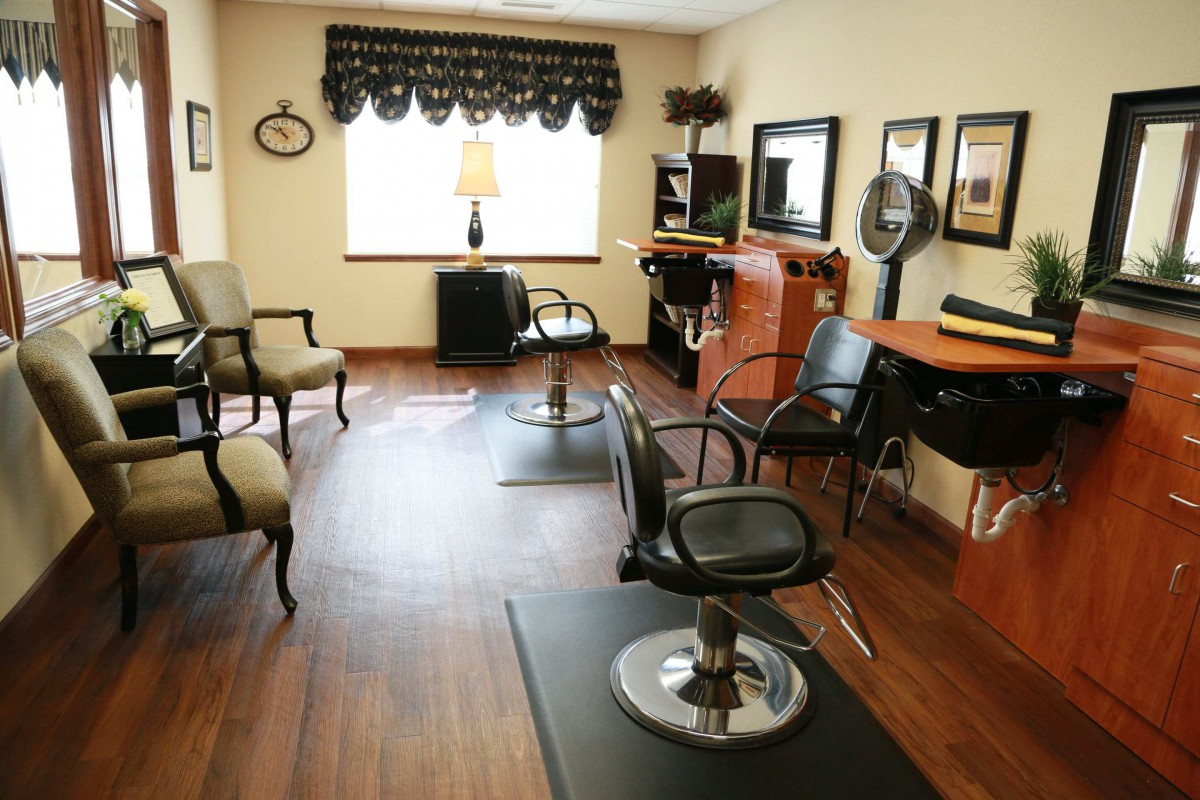 A cozy salon interior with styling stations and a waiting area.