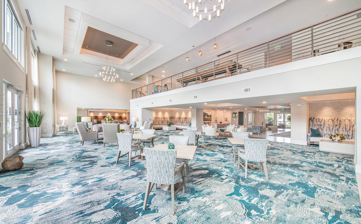A modern, spacious dining area with elegant chandeliers and stylish furniture.