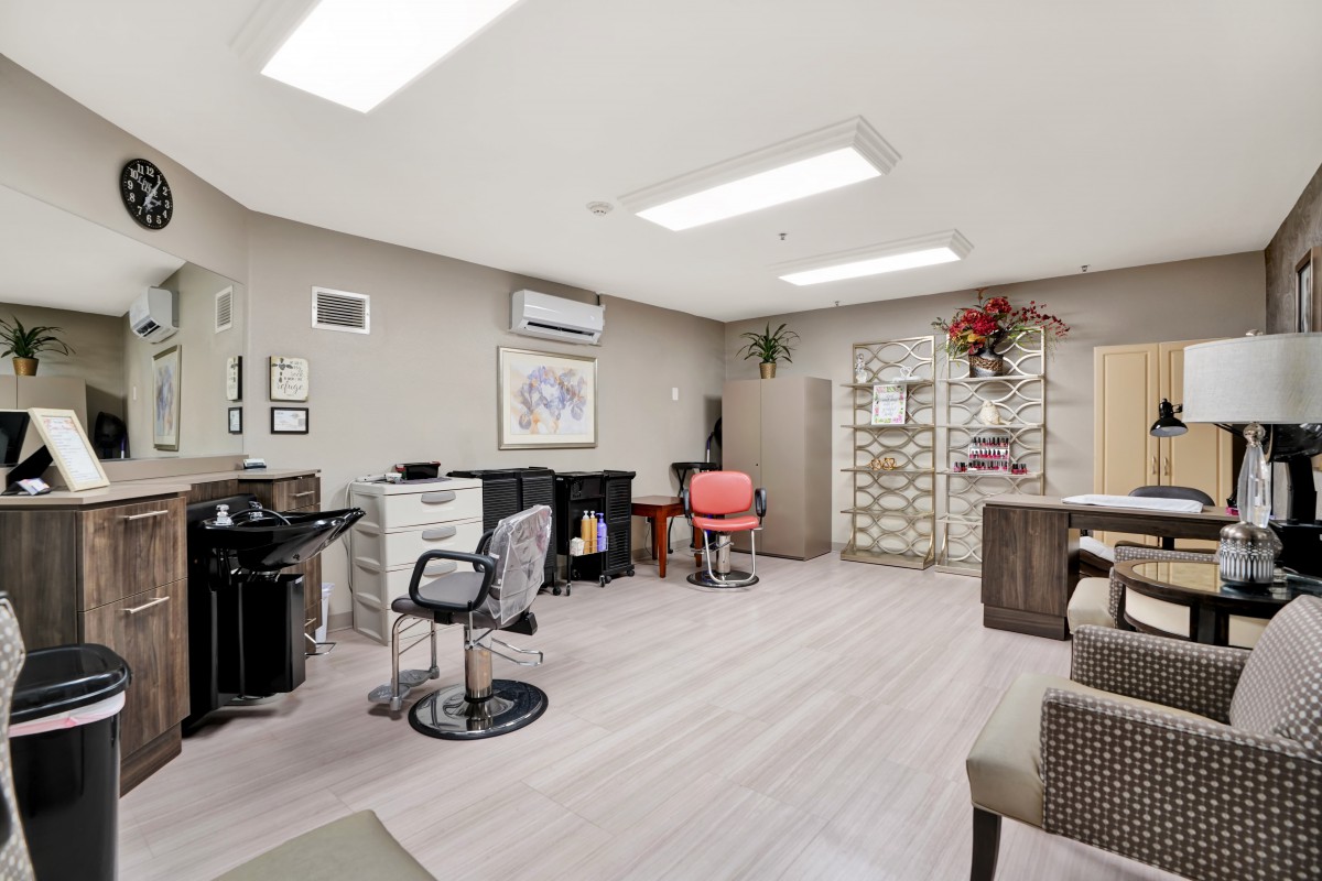 A modern hair salon interior with stylish chairs and mirrors.