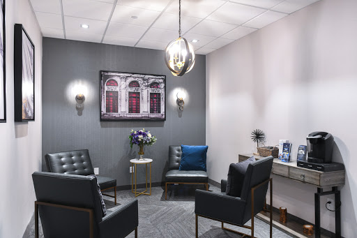 A modern waiting room featuring comfortable seating and stylish decor.