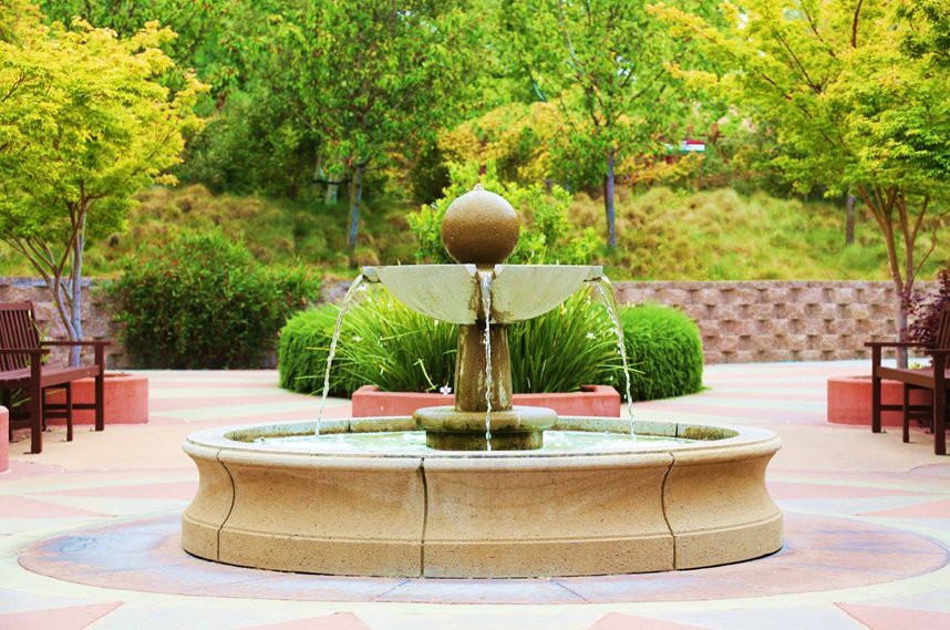 A beautiful fountain in a landscaped garden setting.