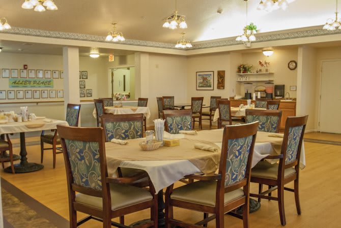 A cozy dining room with neatly arranged tables and chairs.