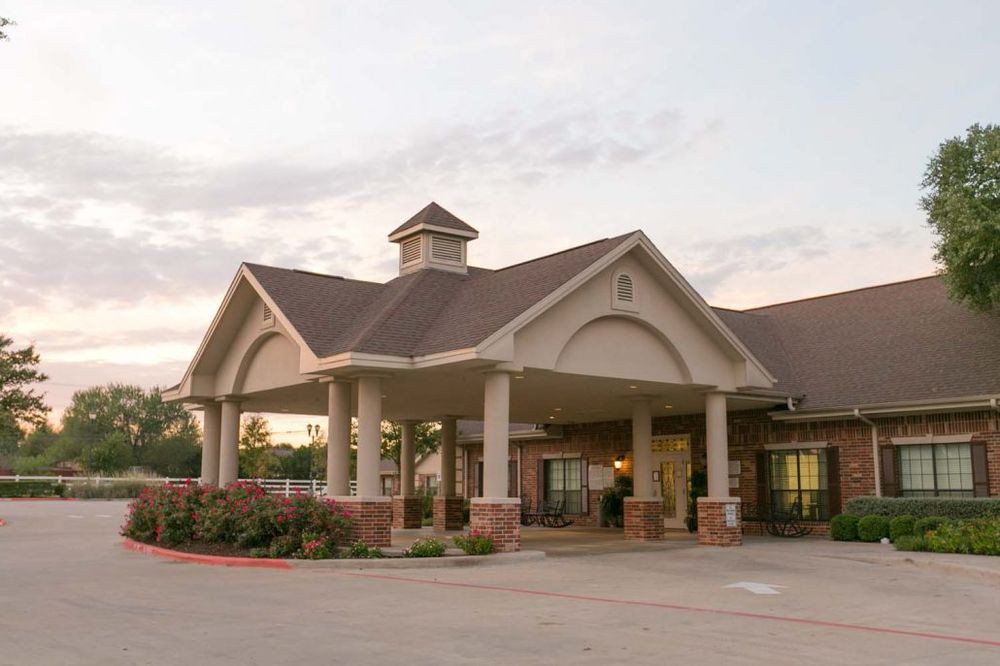 A welcoming building entrance surrounded by well-maintained landscaping.