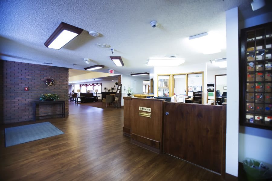 A spacious office lobby with a reception desk and seating area.