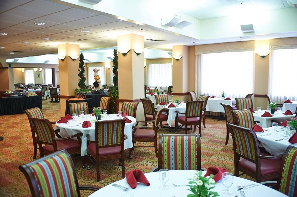 A well-arranged restaurant dining area with neatly set tables and chairs.