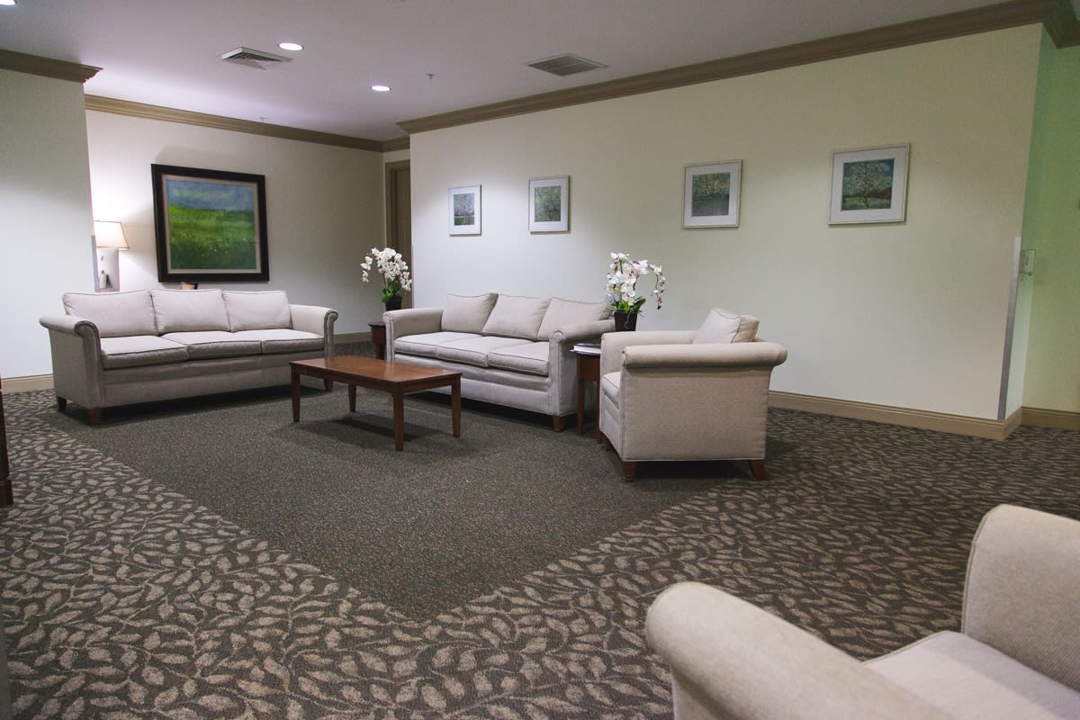 A comfortable lobby area with sofas and artwork on the walls.