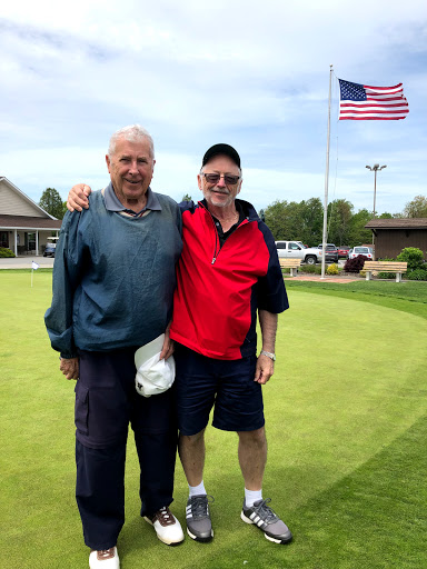 Two friends enjoying a day on the golf course.