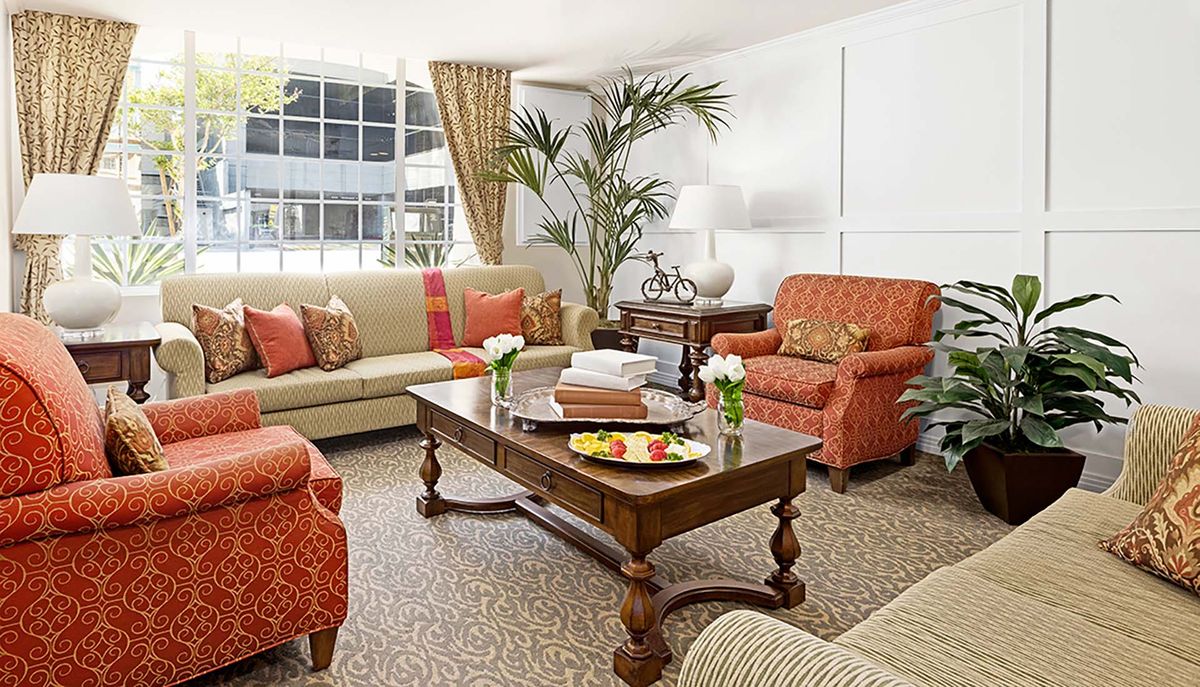 A cozy and elegantly furnished living room with comfortable seating and decorative elements.