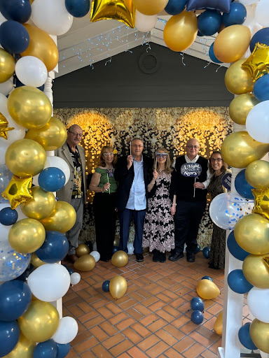 A joyful gathering surrounded by festive decorations and friends.