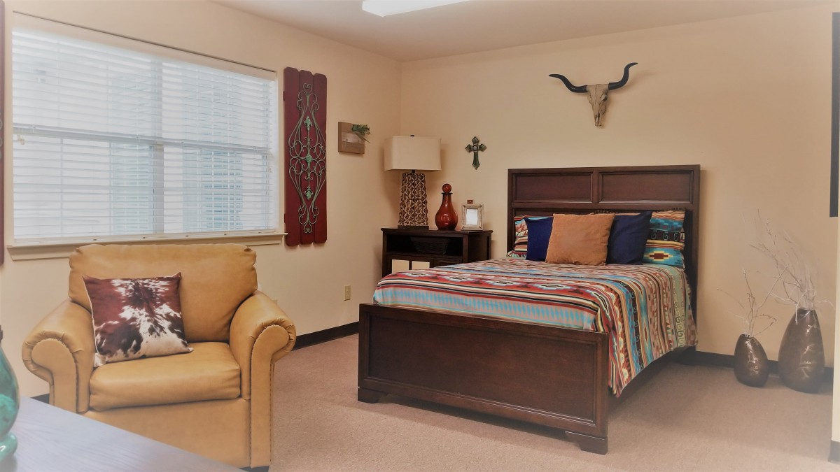 A cozy bedroom with rustic decor and comfortable furnishings.