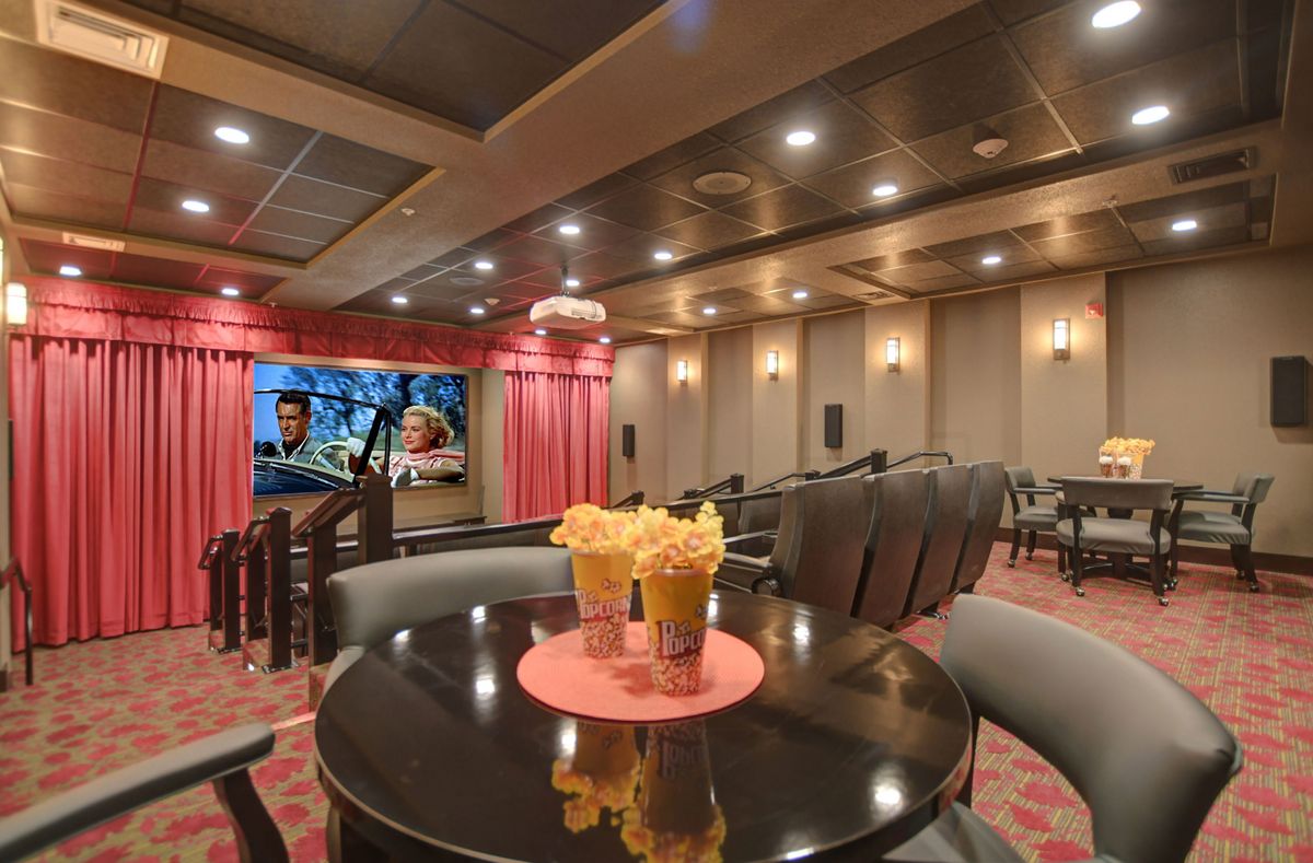 Luxurious home theater with plush seating and freshly prepared popcorn.