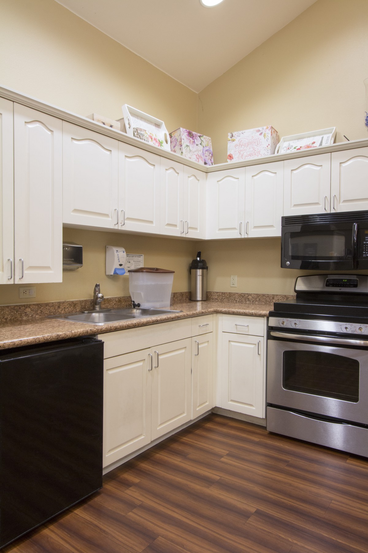 A modern kitchen with white cabinets and stainless steel appliances.