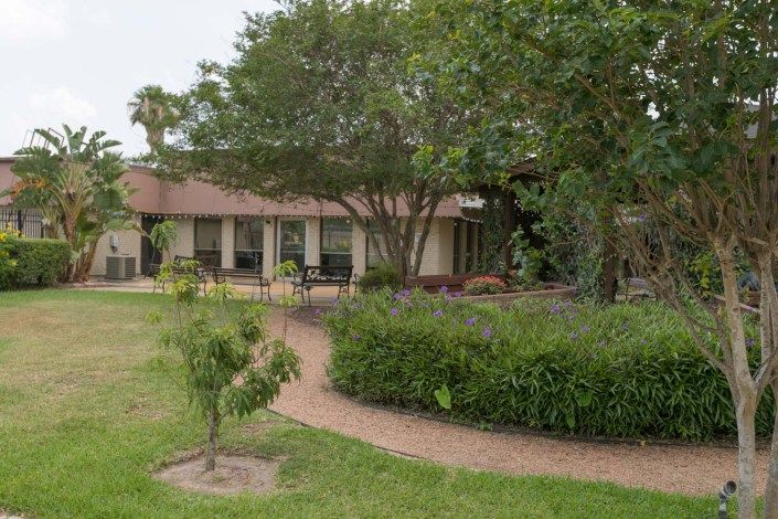 A charming house with a well-maintained garden and winding pathway.