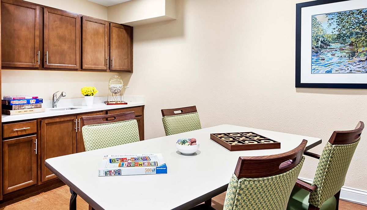 A kitchen table set up for games and puzzles.