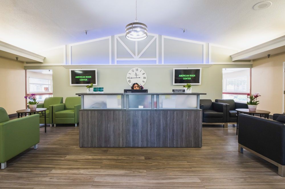 A modern reception area with seating and a central desk.
