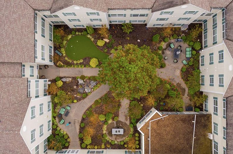 Aerial view of a beautifully landscaped courtyard within a building complex.