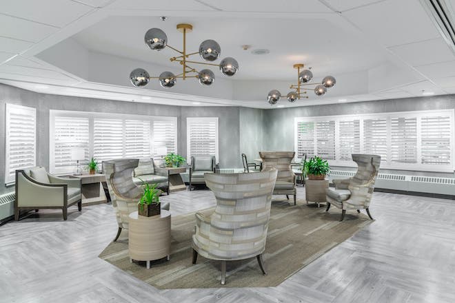 A modern lounge area with stylish seating and contemporary chandeliers.