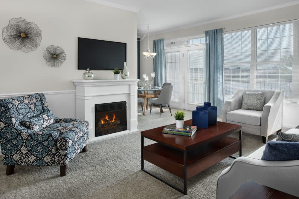 A cozy living room with a fireplace, modern furniture, and elegant decor.