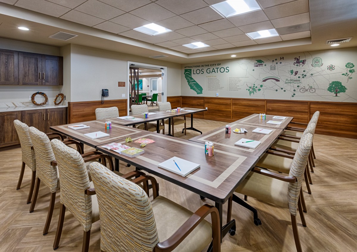 A well-organized conference room set up for a meeting, featuring tables, chairs, and a map-themed wall decoration.