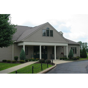 A charming residential building with well-maintained landscaping.