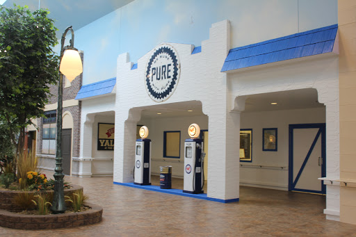 A vintage-style gas station interior with decorative pumps and a classic aesthetic.