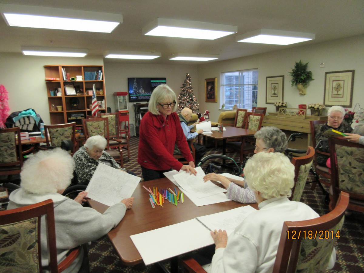 A group of seniors engaged in an art activity at a community center.