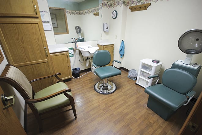 A small medical examination room with seating and basic amenities.