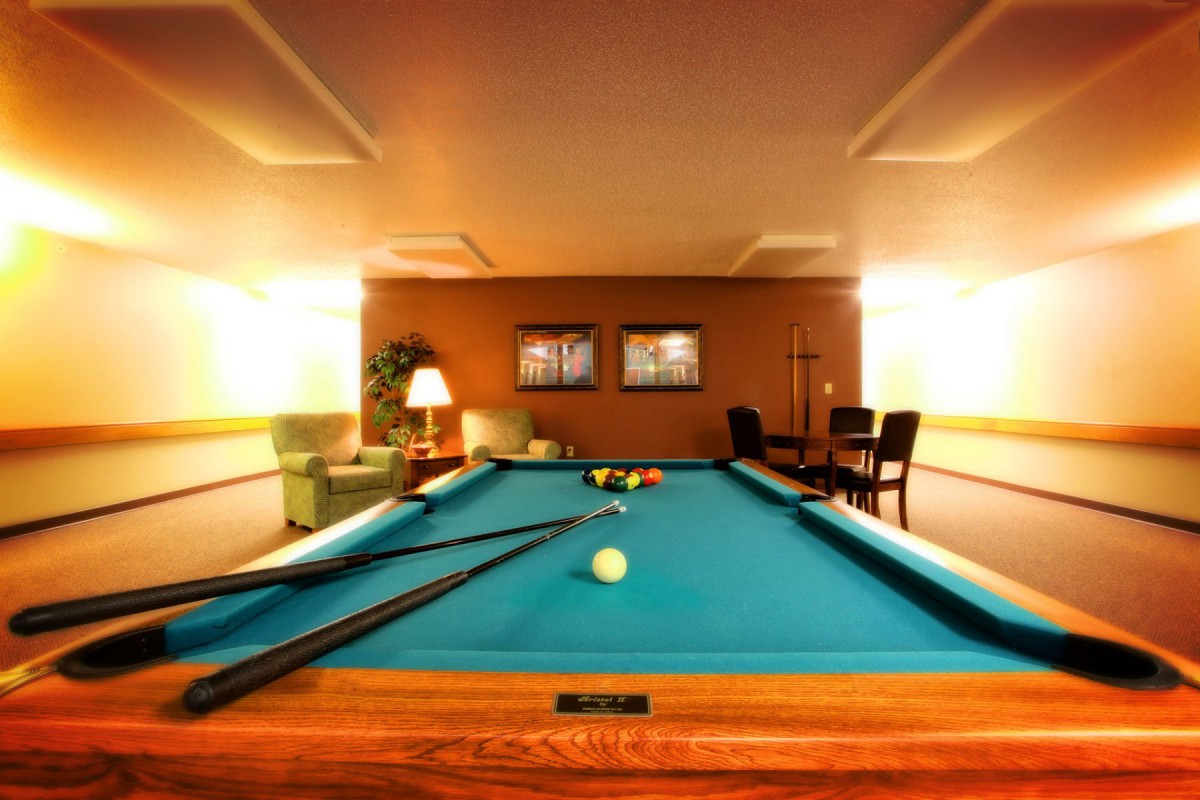 A cozy game room featuring a pool table ready for play.