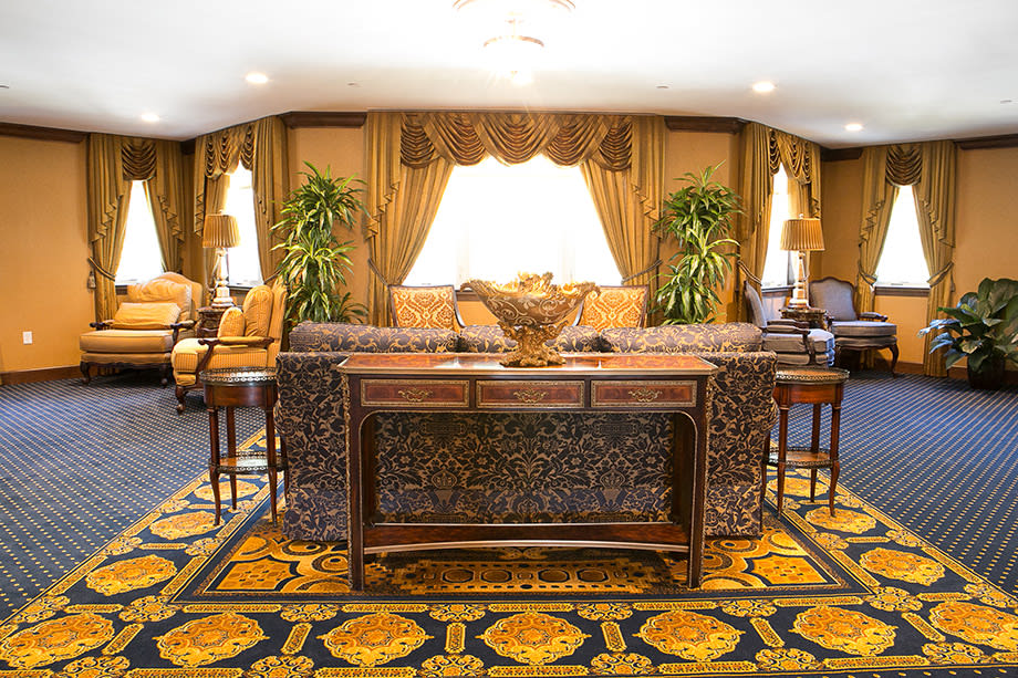 A luxurious and elegantly decorated living room with traditional furnishings.