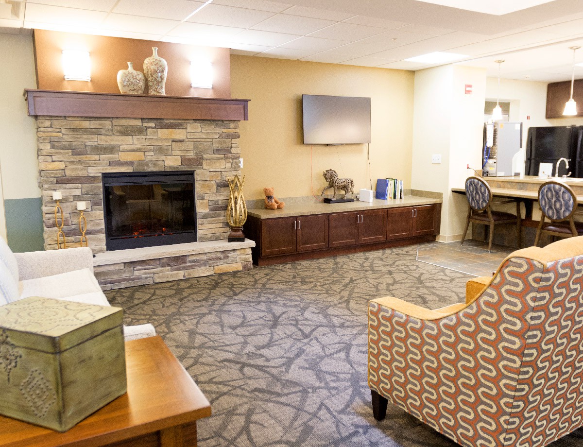 A cozy living room with a fireplace and comfortable seating.