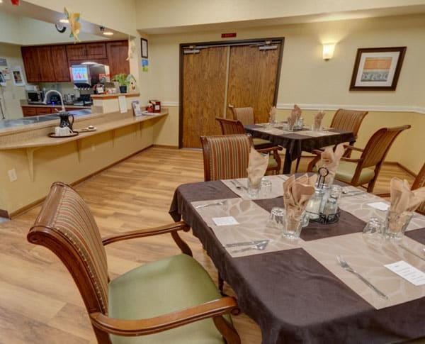 A cozy dining area with neatly set tables and chairs, ready for guests.