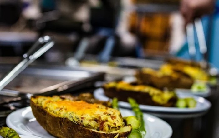 A dish featuring a cheesy stuffed potato served on a plate.