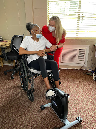 A moment of support and encouragement in a rehabilitation setting.