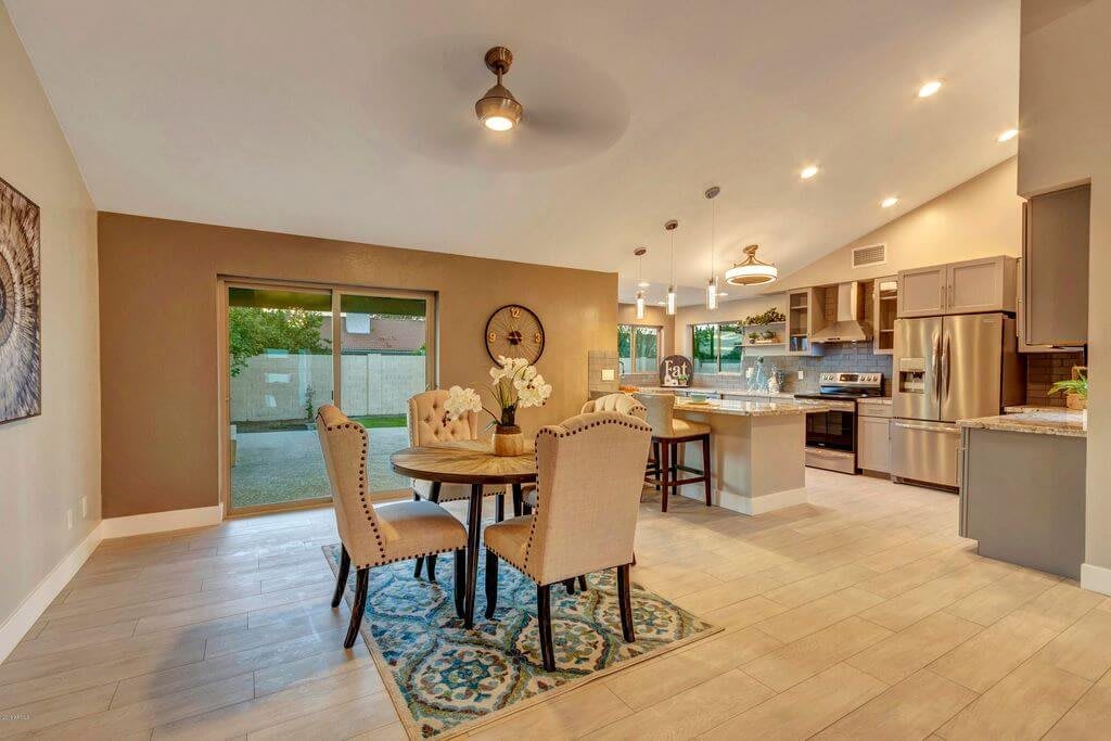 A modern open-concept kitchen and dining area with stylish decor and ample lighting.