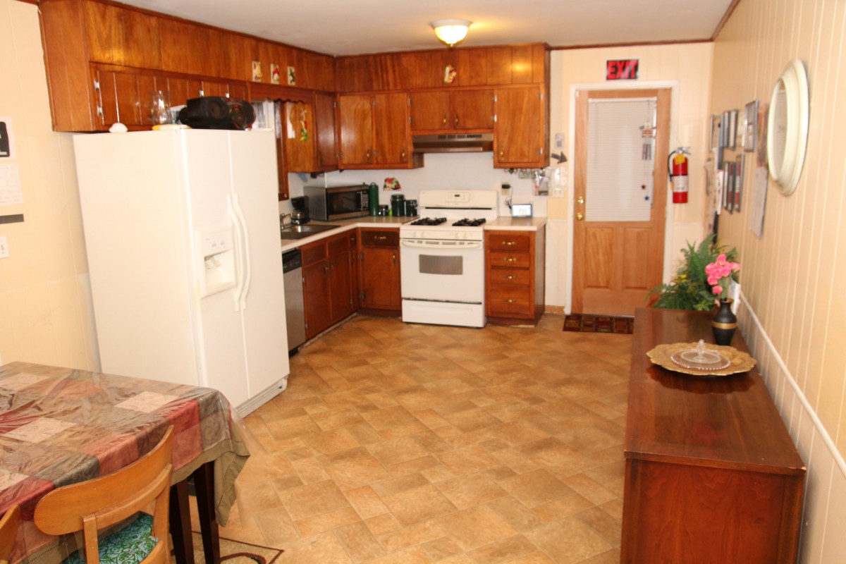 A spacious kitchen with wooden cabinets and modern appliances.