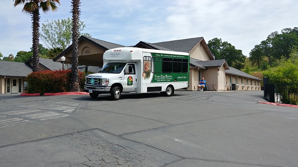 A shuttle bus parked in front of a building.
