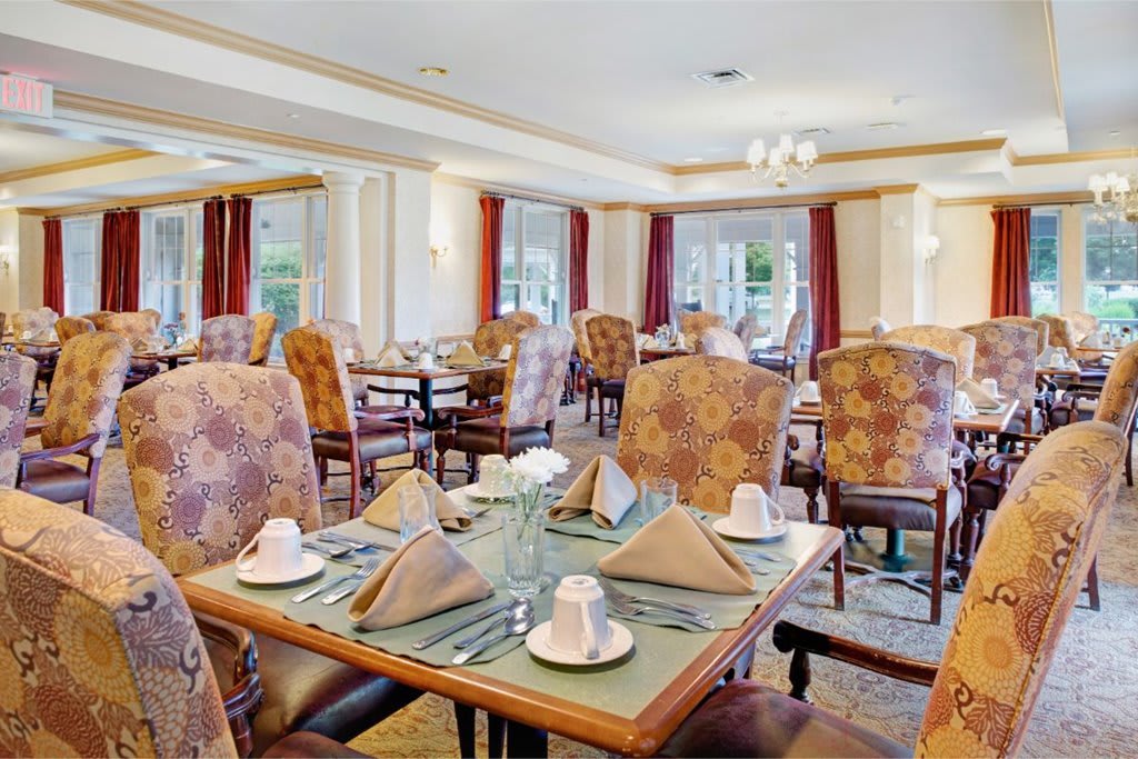 A well-arranged dining area with elegant furnishings and table settings.