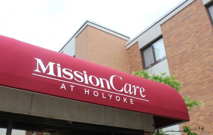 Entrance of MissionCare at Holyoke with a red awning.
