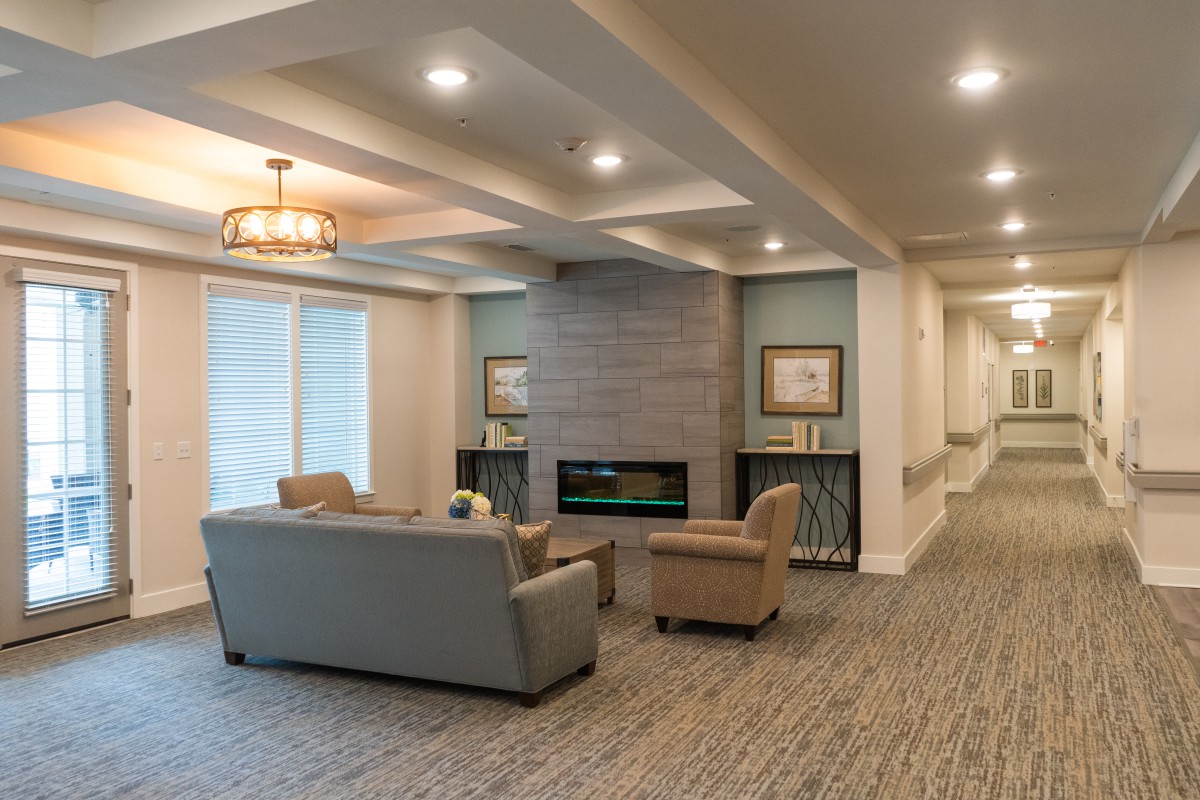 A modern living room with comfortable seating and a cozy fireplace.