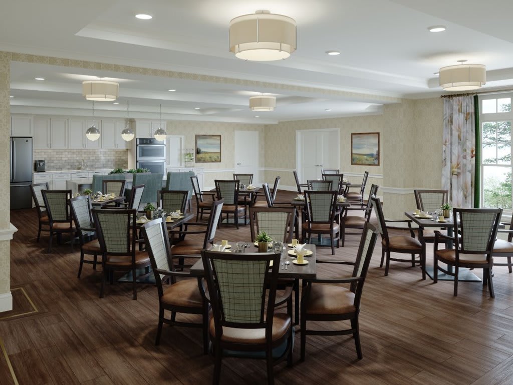 A modern dining room with neatly arranged tables and chairs, complemented by soft lighting and tasteful decor.