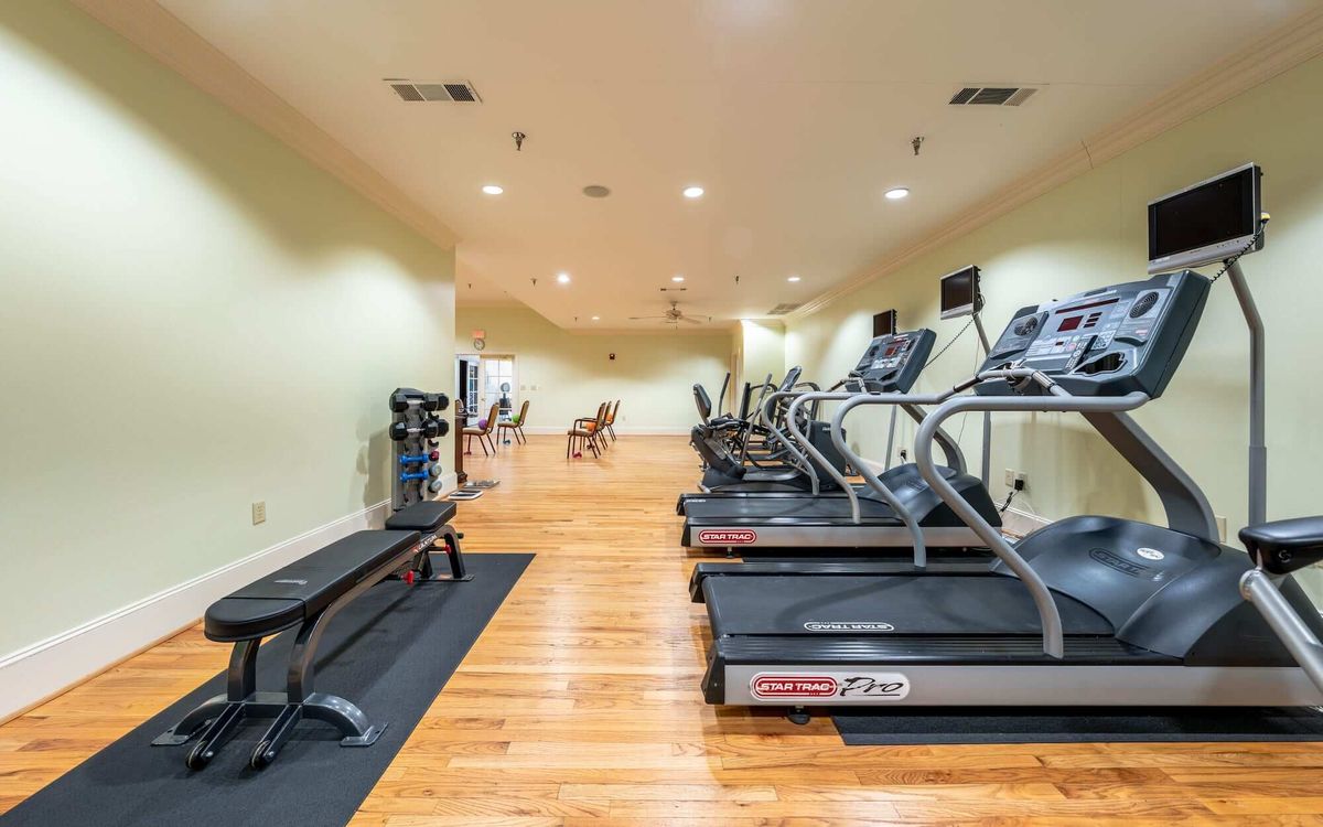 A spacious gym with treadmills and various exercise equipment.