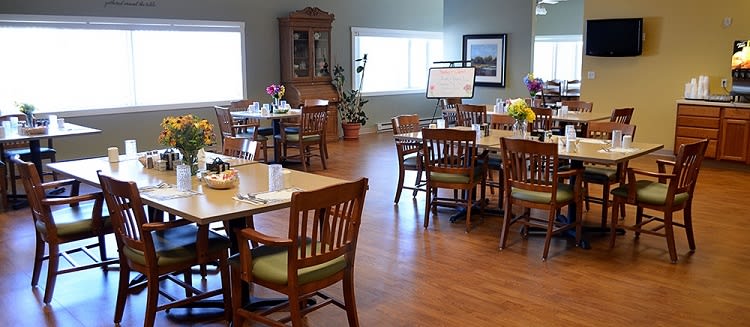 A cozy dining area with neatly arranged tables and chairs.