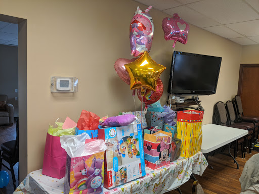 A colorful birthday party setup with gifts and festive balloons.