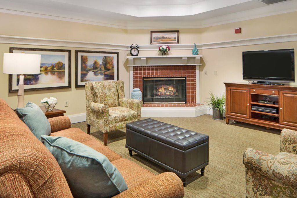 A cozy living room with a fireplace and comfortable seating.