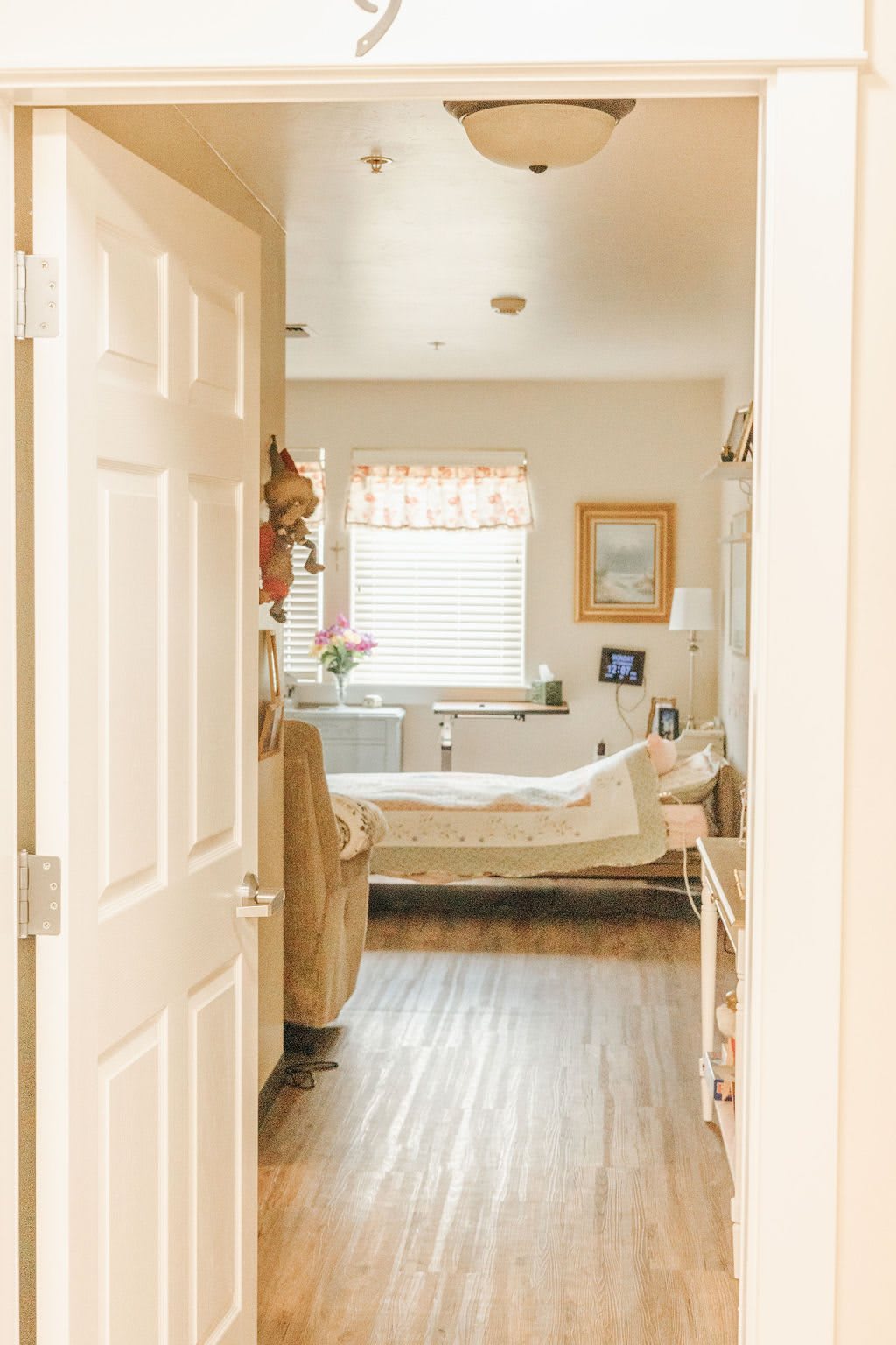 A cozy bedroom with a neatly made bed, soft lighting, and tasteful decor.